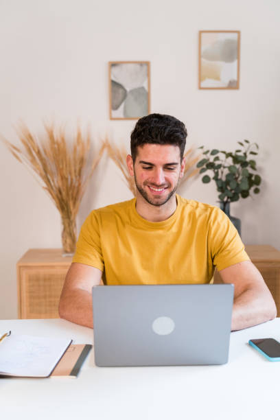 istock Happy man working on laptop 1458449186