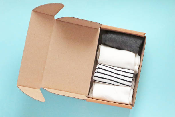 istock Craft Cardboard Box Container with socks on the blue background 1458449624