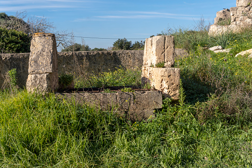Old stone irrigation ditch and a well in disuse and in a ruinous state. Drought problem in Spain. Island of Mallorca, Spain
