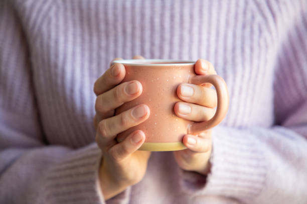 istock Woman holding a mug in hands 1458459960