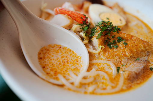 Laksa is a bit of spicy noodle soup and one of my favorite dishes in Singapore. \nThere are various kinds of Laksa across the region. My favorite might be Penang type os Laksa. Whatever it is, coconut based soup is very delicious.