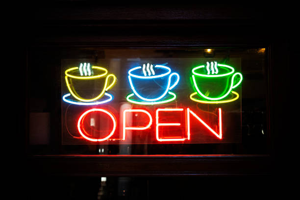 istock Neon open sign with coffee cup on glass door. open cafe. 1458463427