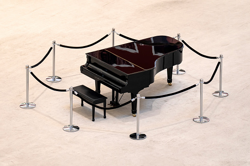 Grand piano on white background, top view. classic black piano on stage