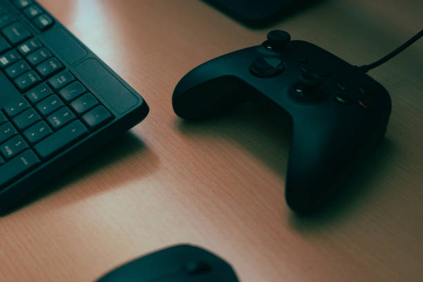 istock Mouse, keyboard, video game controller. Complements of a computer on a desk 1458463718