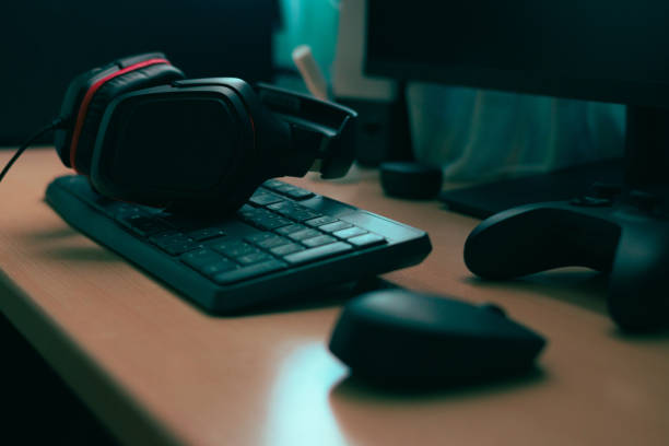 istock Mouse, keyboard, headphones, video game controller. Complements of a computer on a desk 1458464247