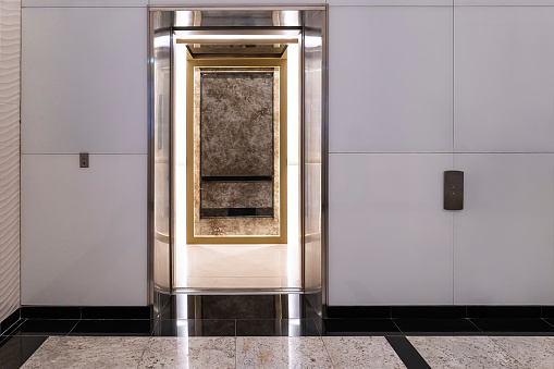 modern elevator with open door, buttons on the wall