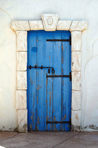 istock A small blue wooden door with a rock frame 145846546