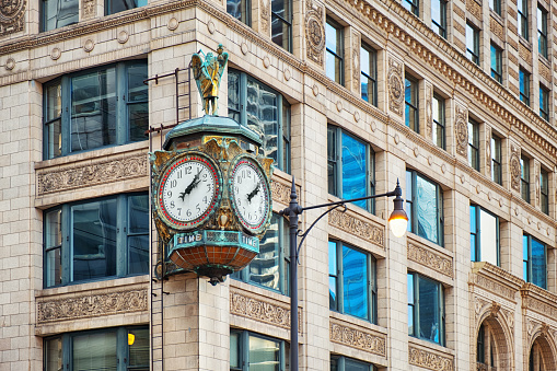 New York City, NY, USA - July 16 2014: View of One Madison building, Flatiron Building and the cast-iron sidewalk clock outside the Toys Center in Madison Square, Manhattan.