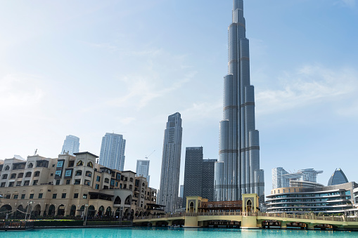 Dubai, UAE , United Arab Emirates. November 27th, 2022. Burj al Khalifa, the tallest building in the world. bridge and artificial lake with fountains and a tower