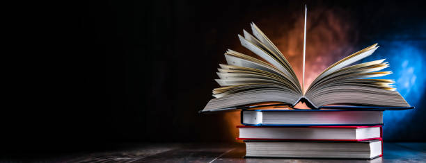istock A composition with an open book lying on a stack of other books 1458467898