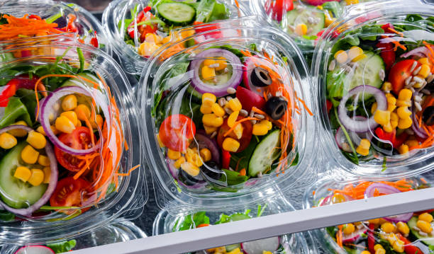 istock Boxes with pre-packaged vegetable salads in a commercial fridge 1458467965