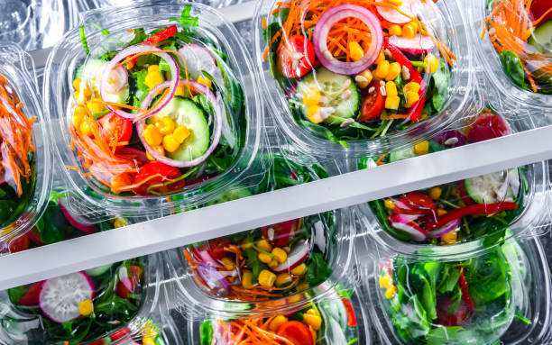 istock Boxes with pre-packaged vegetable salads in a commercial fridge 1458468159