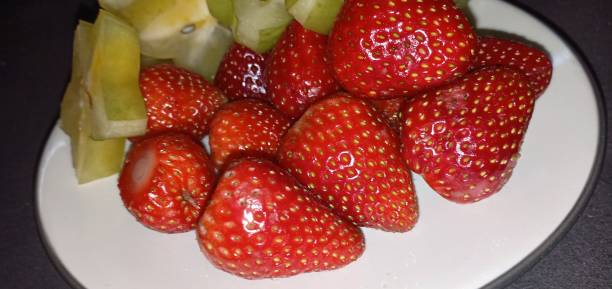 istock fresh fruit consisting of strawberries and star fruit. 1458468981