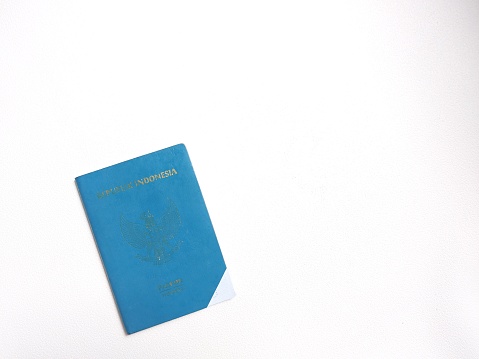 Indonesian passport in green cover. With indonesian text 'Rebuplik Indonesia' and paspor. It means 'indonesia republic' and 'passport'. Isolated background in white