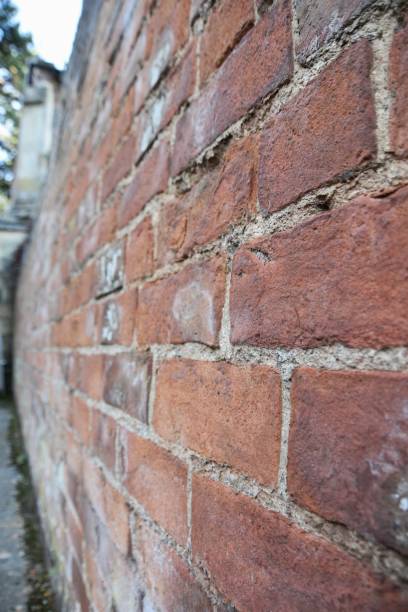 istock Old masonry Brick wall alley view 1458471011