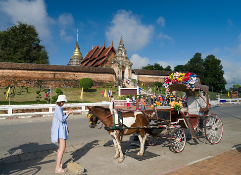 Lampang, Thailand. November 21, 2022. Wat Phra That Lampang Luang Temple.Tradition horse retro carriage. Tourist destination of Northern Thailand. Asia travel area.