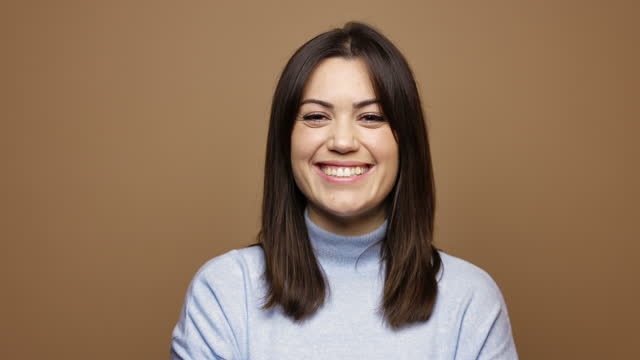 Happy Woman against Brown Background