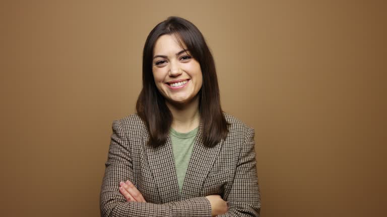 Happy Spanish Businesswoman against Brown Background