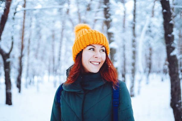 istock Young beautiful woman in winter forest 1458479318