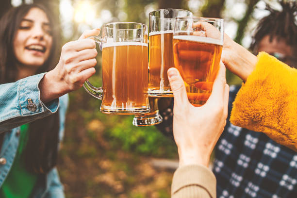 istock Happy friends toasting with beers 1458480321