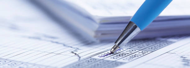 istock Checking the value of securities. Pencil, share listing and checking financial chart. Concept of banking, financial report and financial audit. 1458480680
