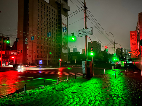 Kyiv, Ukraine - 16 January 2023: Blackout in the Ukraine streets without street lighting only reflection color of traffic light and cars lights.