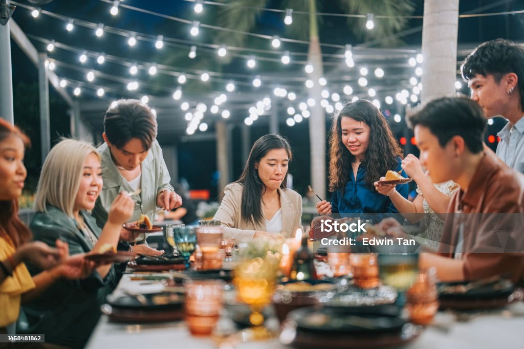 Asian Chinese Lesbian Couple celebrating birthday outdoor dining with friends Restaurant Stock Photo