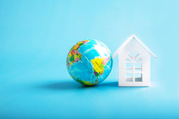 istock house and earth globe on blue background, environmental protection eco concept 1458482548