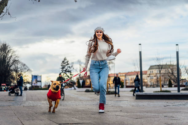 istock Young woman running with her dog 1458482706