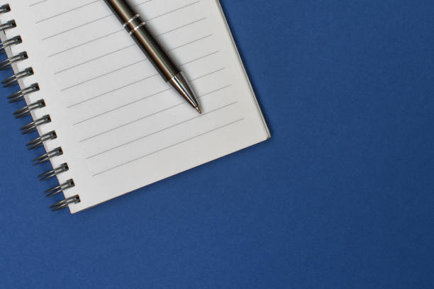 istock A notebook with a blank page and a pen resting on it 1458483795