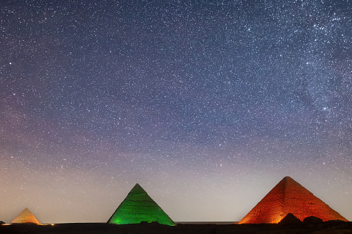 Pyramids of Giza, Egypt - July 26, 2022: All three of Giza's pyramids and their elaborate burial complexes were built  from roughly 2550 to 2490 B.C. The pyramids were built by Pharaohs Khufu, Khafre, and Menkaure.\n\nIn ancient times the pyramids were included among the Seven Wonders of the World. The ancient ruins of the Memphis area, including the Pyramids of Giza, Ṣaqqārah, Dahshūr, Abū Ruwaysh, and Abū Ṣīr, were collectively designated a UNESCO World Heritage site in 1979.