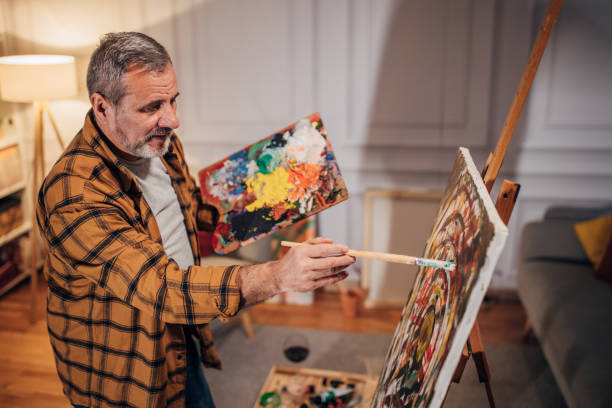 istock A male artist paints on a canvas in his studio 1458483933