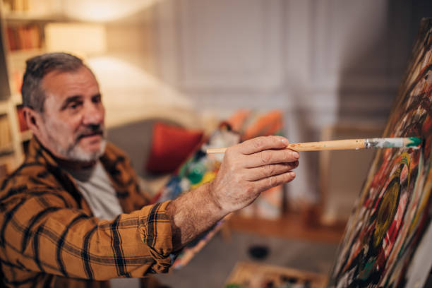 istock A male artist paints on a canvas in his studio 1458483934