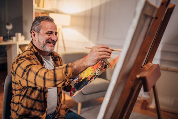 istock A male artist paints on a canvas in his studio 1458483937
