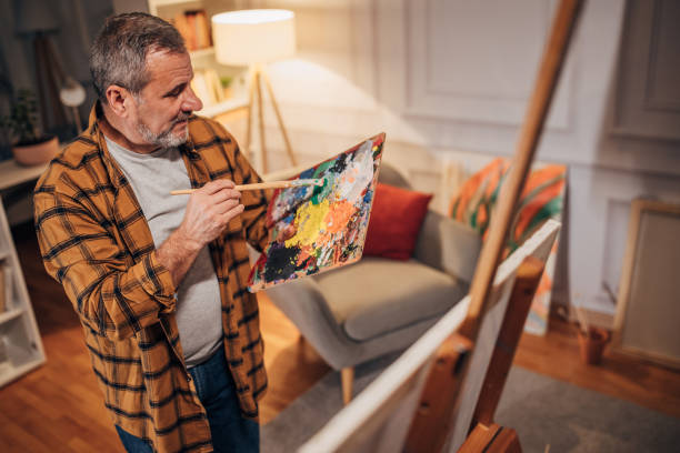 istock A male artist paints on a canvas in his studio 1458484023