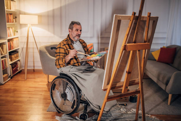 istock A man in a wheelchair paints on a canvas in a studio 1458485517