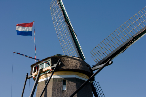 Dutch windmills at Queensday. During that day all the windmills in The Netherlands are carrying the Dutch flag, to celebrate the birthday of the Dutch Queen Beatrix.