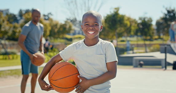 Basketball, black child and happy portrait with a ball for sports, fitness and exercise outdoor. Excited kid and man or dad at a family park with energy, game and action for performance on court