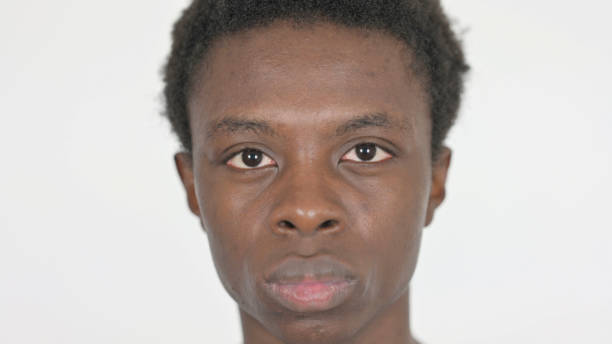 istock Face of Serious Young African Man on White Background 1458487657