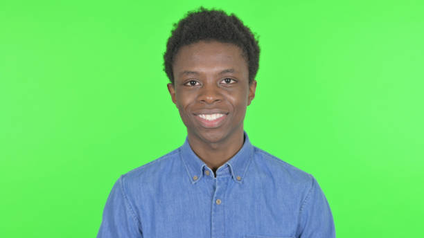 istock Smiling Young African Man on Green Background 1458487916