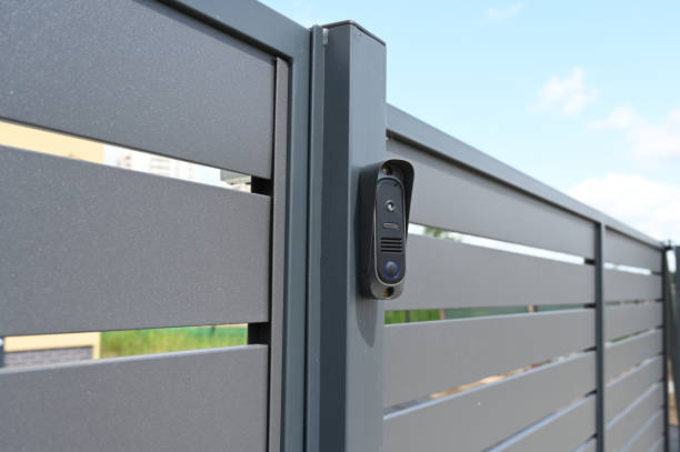 istock Black intercom call panel on a mounted in panel fence in anthracite color, visible wicket.Entrance to the private house. 1458489200