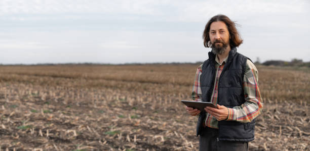 istock Farmer with digital tablet on a field. 1458490455