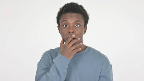 istock Shocked Young African Man Feeling Surprised on White Background 1458491233