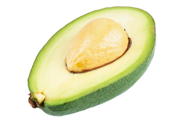 アボカドは白地に骨を分離して半分に切った。新鮮な野菜。 - avocado portion brown apple core ストックフォトと画像