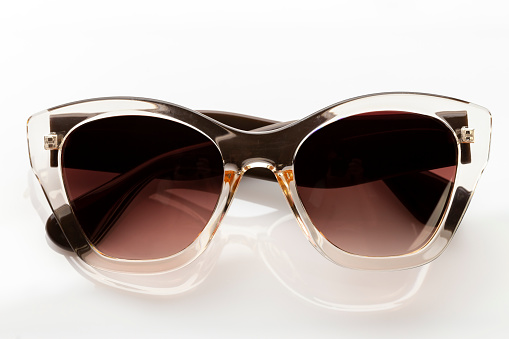 Cat's eye women's sunglasses with brown frame and glass, white background, cut out, clipping path