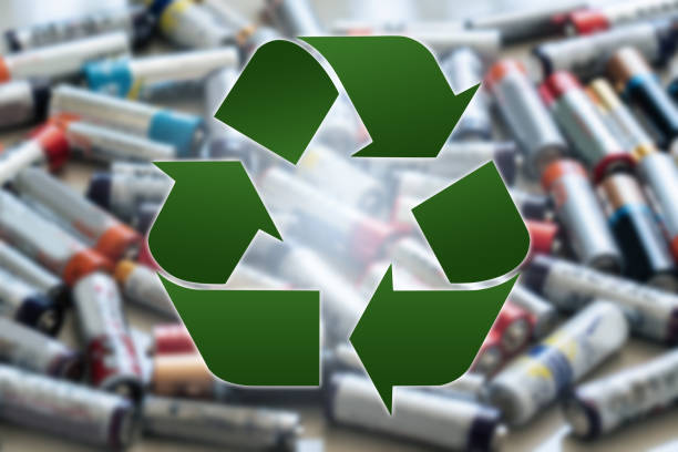 istock Recycling symbol on a background of used battery 1458494864