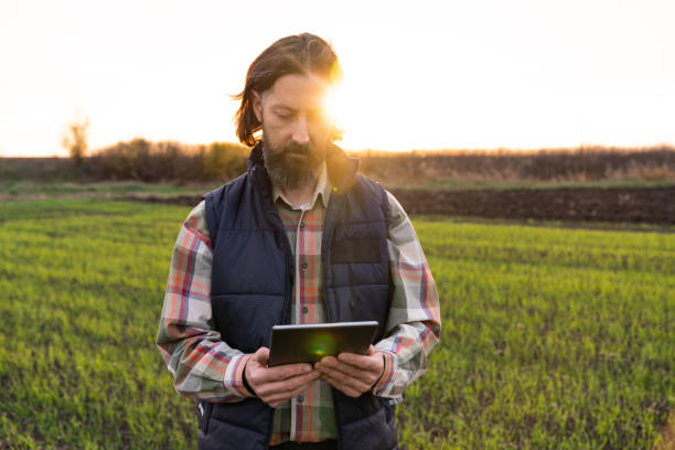 istock Farmer with digital tablet on a field. 1458495086