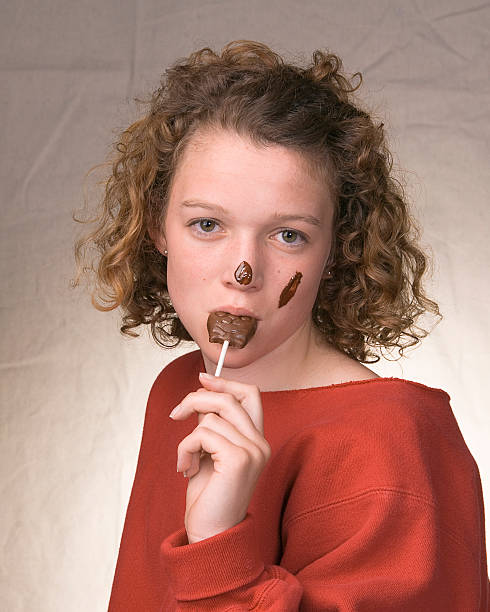 Girl Eating Chocolate stock photo