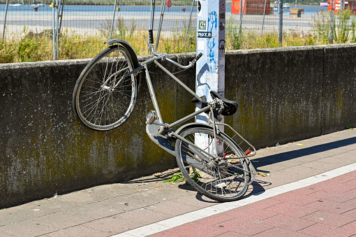 Antwerp, Belgium - August 2022: Bicycle with buckled wheel damaged on one of the city's streets