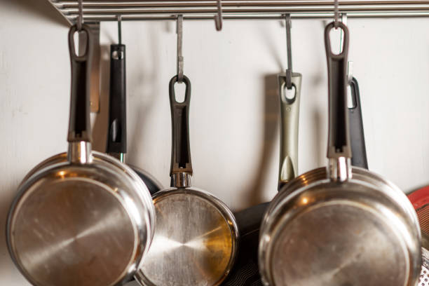 istock Pots and pans hang in the kitchen. Kitchen utensils, home interior. 1458497075